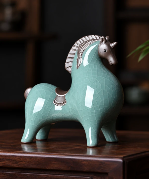 Celadon horse figurine with a dark mane on a wooden display surface