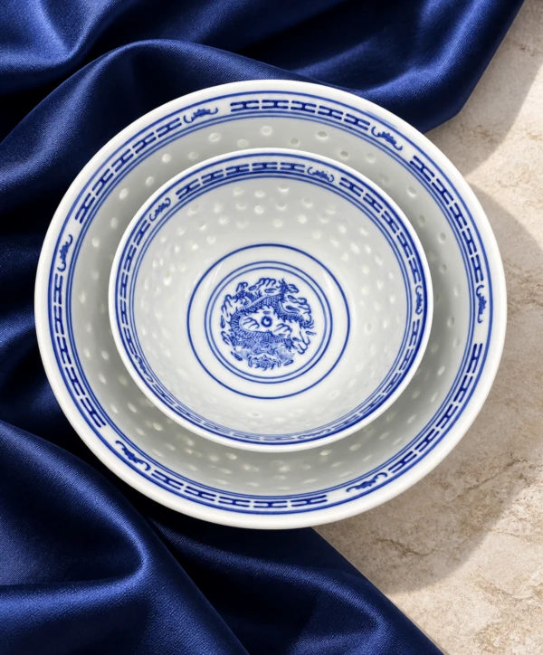 Blue and white patterned porcelain bowls viewed from above on blue fabric