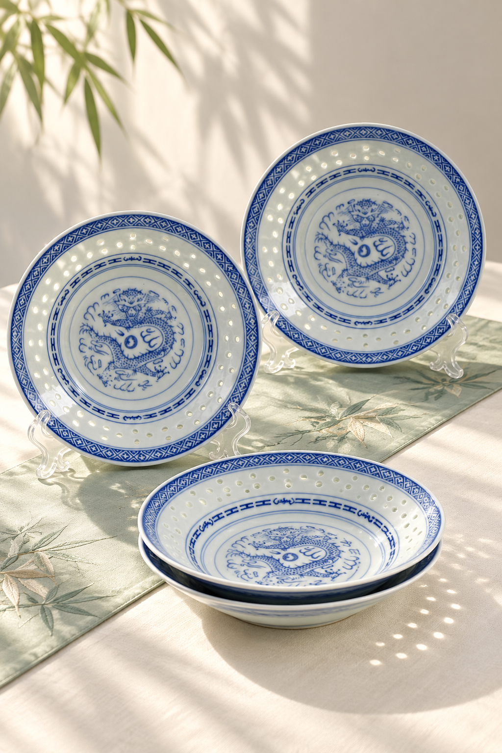 Blue and white dragon-pattern tableware displayed in natural window light