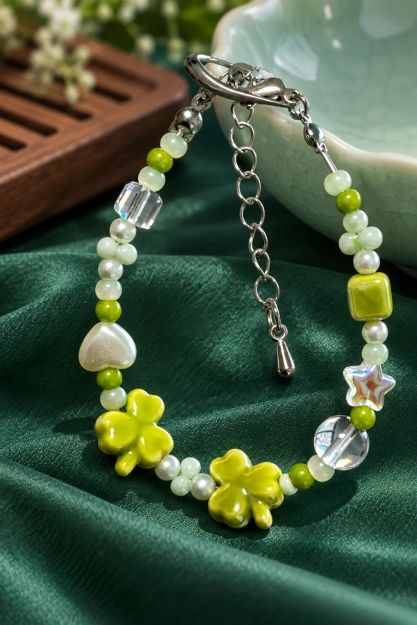 Green clover bracelet with pale beads, clear accents and an extension chain