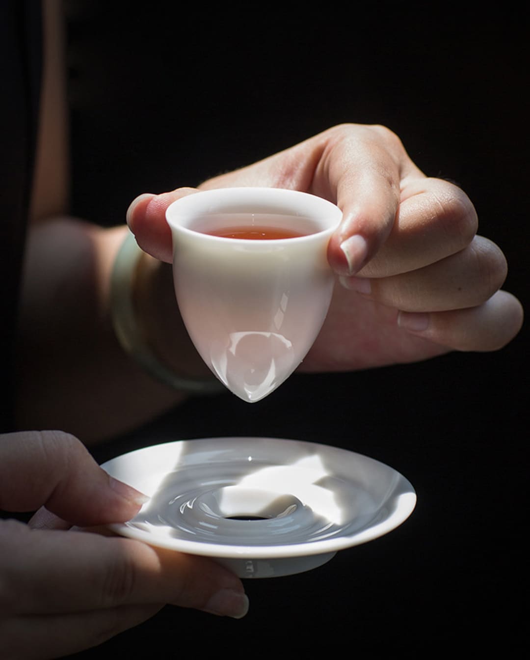 Playful White Porcelain Pointed-Bottom Tea Cup with Cradle Saucer