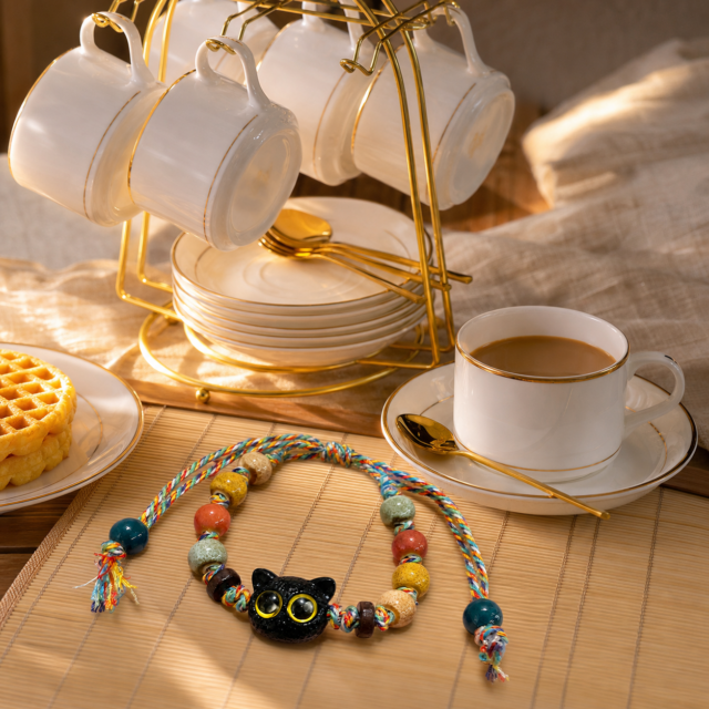 Leo Golden Hour Pairing — Black Cat Bracelet & Gold-Rim Tea Set